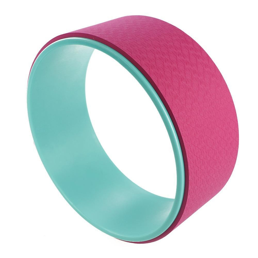 Pink and teal yoga wheel on a white background