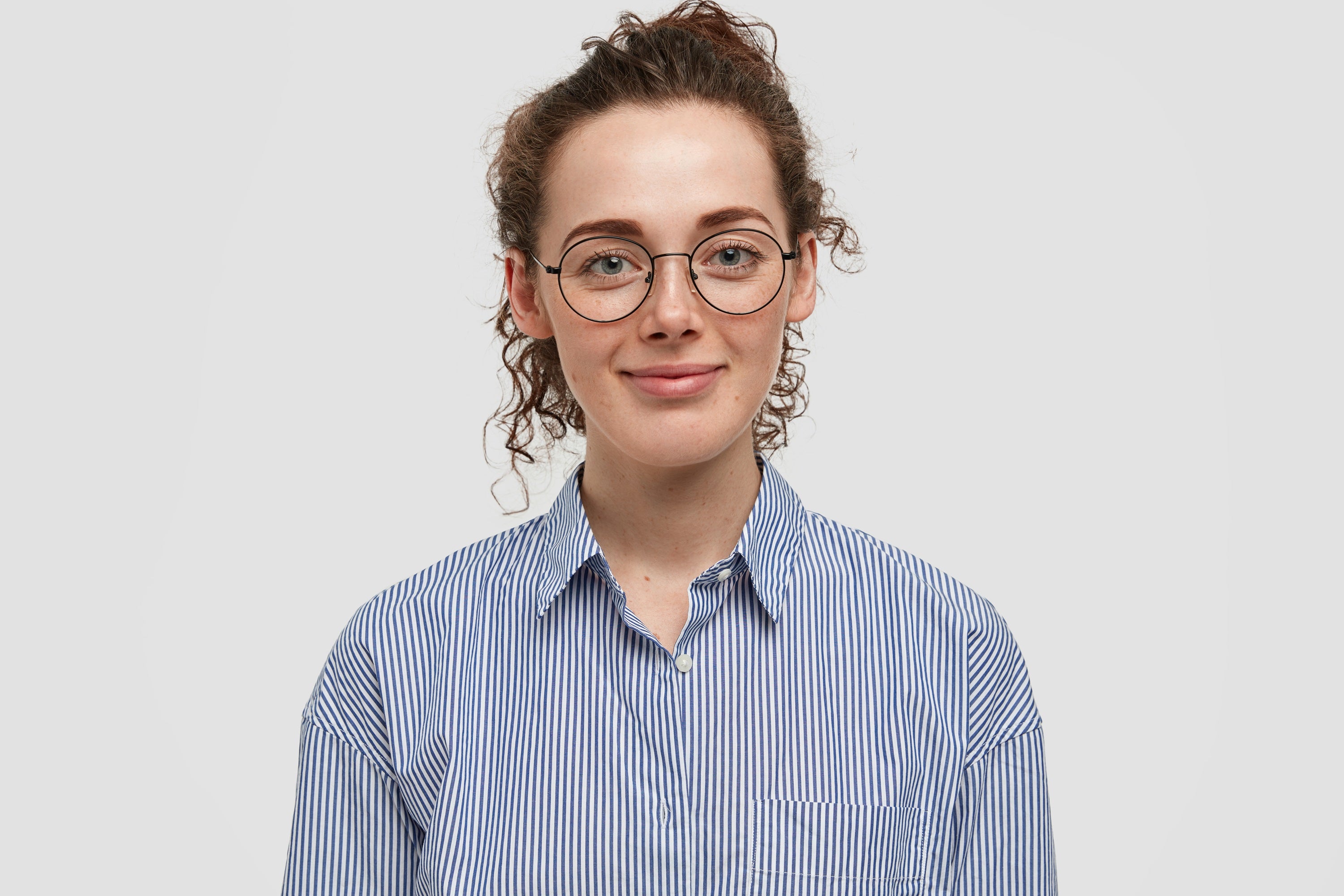 Person wearing a blue striped shirt against a plain background