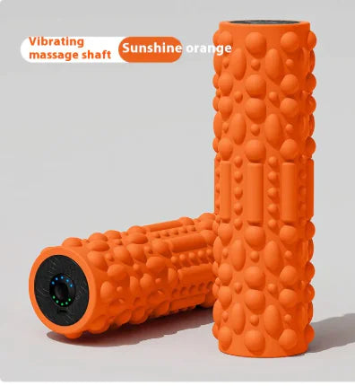 Orange foam roller with a vibrating massage shaft on a light gray background