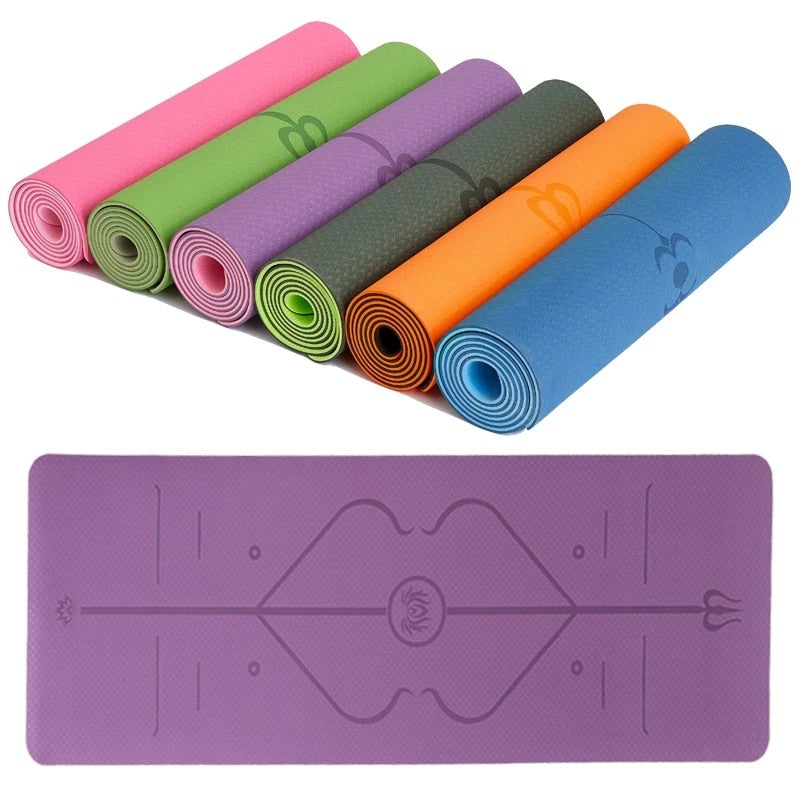 Set of colorful rolled-up yoga mats with a purple mat displayed below on a white background.