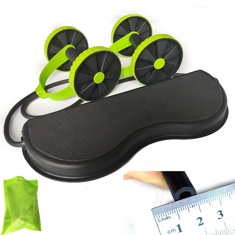 Black and green ab roller with packaging and ruler for scale on a white background