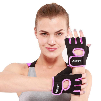 Woman wearing black and pink fitness gloves with visible branding on a white background