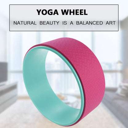 Pink and green yoga wheel with a blurred indoor background and text overlay.