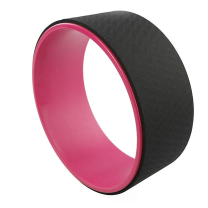 Black and pink yoga wheel on a white background