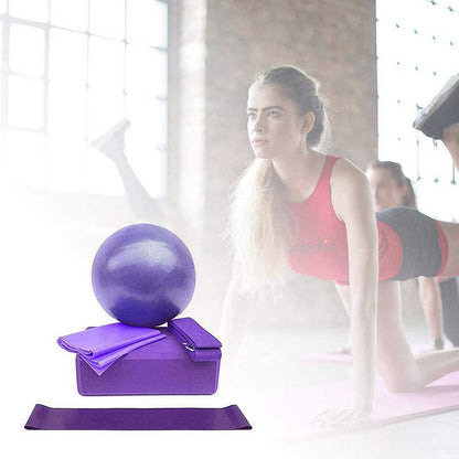 Woman exercising with fitness equipment including a purple ball and block in a bright room.