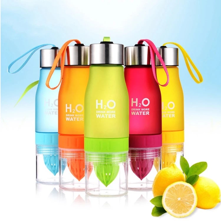 Set of colorful H2O water bottles with lemon slices on a light blue background