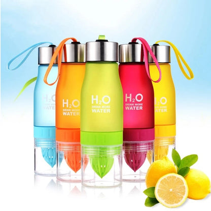 Set of colorful H2O water bottles with lemon slices on a light blue background