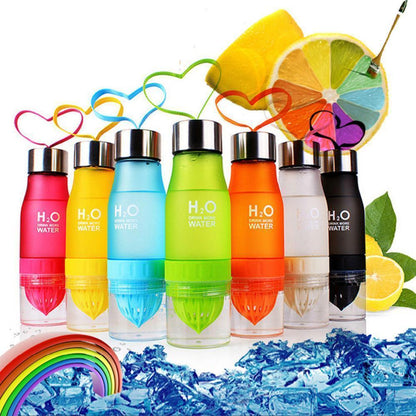 Set of colorful H2O water bottles with lemon slices and ice cubes on a white background