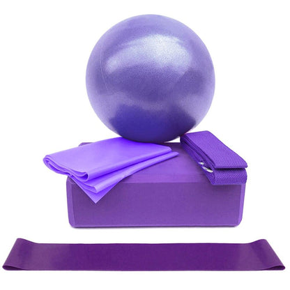 Purple exercise ball, block, and resistance bands on a white background