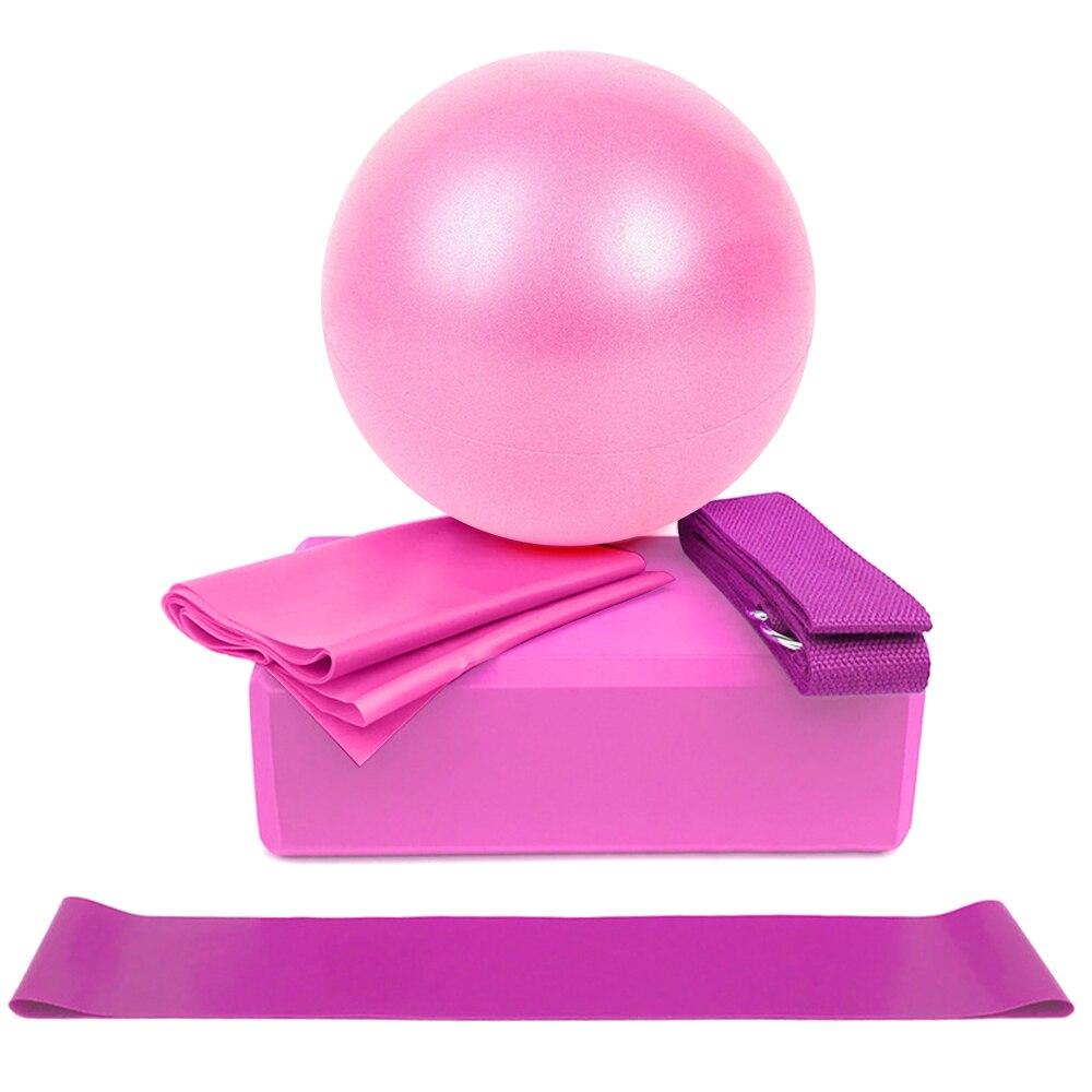 Pink exercise ball, pink resistance band, and purple strap on a white background