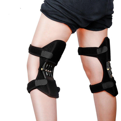 Black knee brace on a person's legs against a white background