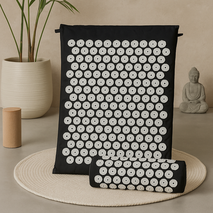 Black acupressure mat with white dots on a beige surface, surrounded by decorative items.