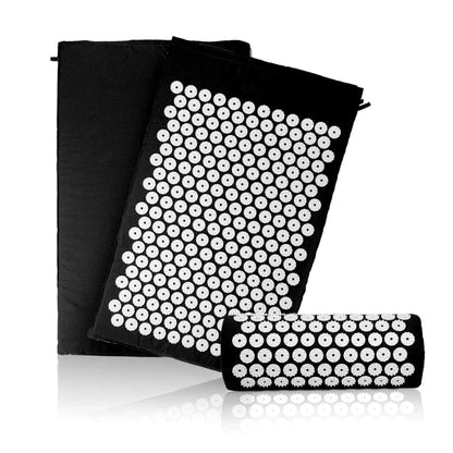 Black acupressure mat with white nodes on a white background