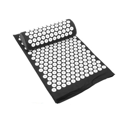 Black acupressure mat with white nodes on a white background