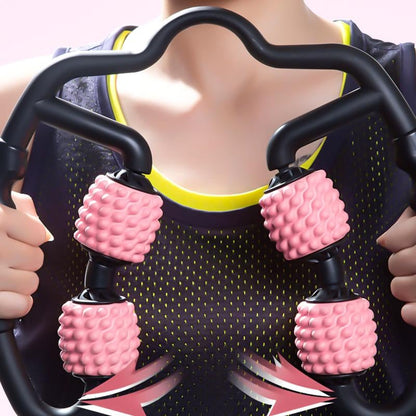 Person using a pink and black massage tool with textured handles.