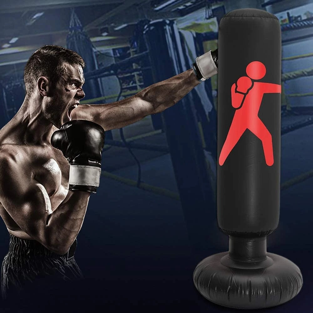 Muscular man in boxing stance with a punching bag featuring a red figure in a gym.