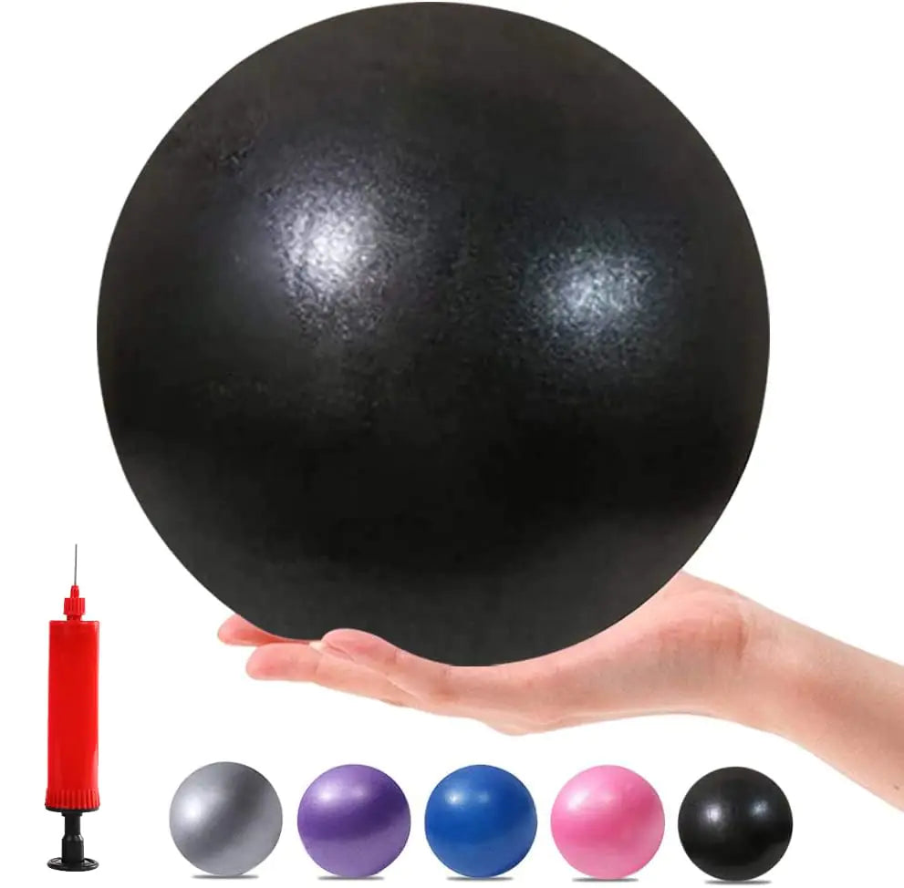 Black exercise ball with a hand holding it and a red pump on a white background
